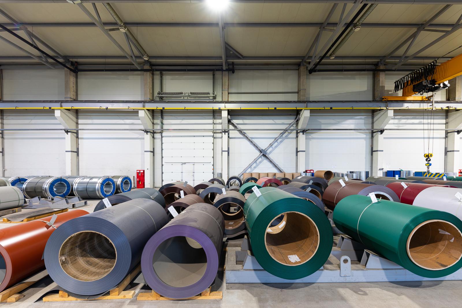 Photo shot of rolls of steel sheet stored in warehouse; Cold rolled steel coils at the factory. Engineering production Photo shot of rolls of steel sheet stored in warehouse; Cold rolled steel coils at the factory. Engineering production