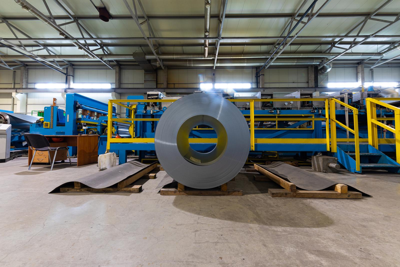 Metal tile for roof in metallic forming machine production line in factory. Cold rolled steel coils at the plant Metal tile for roof in metallic forming machine production line in factory. Cold rolled steel coils at the plant